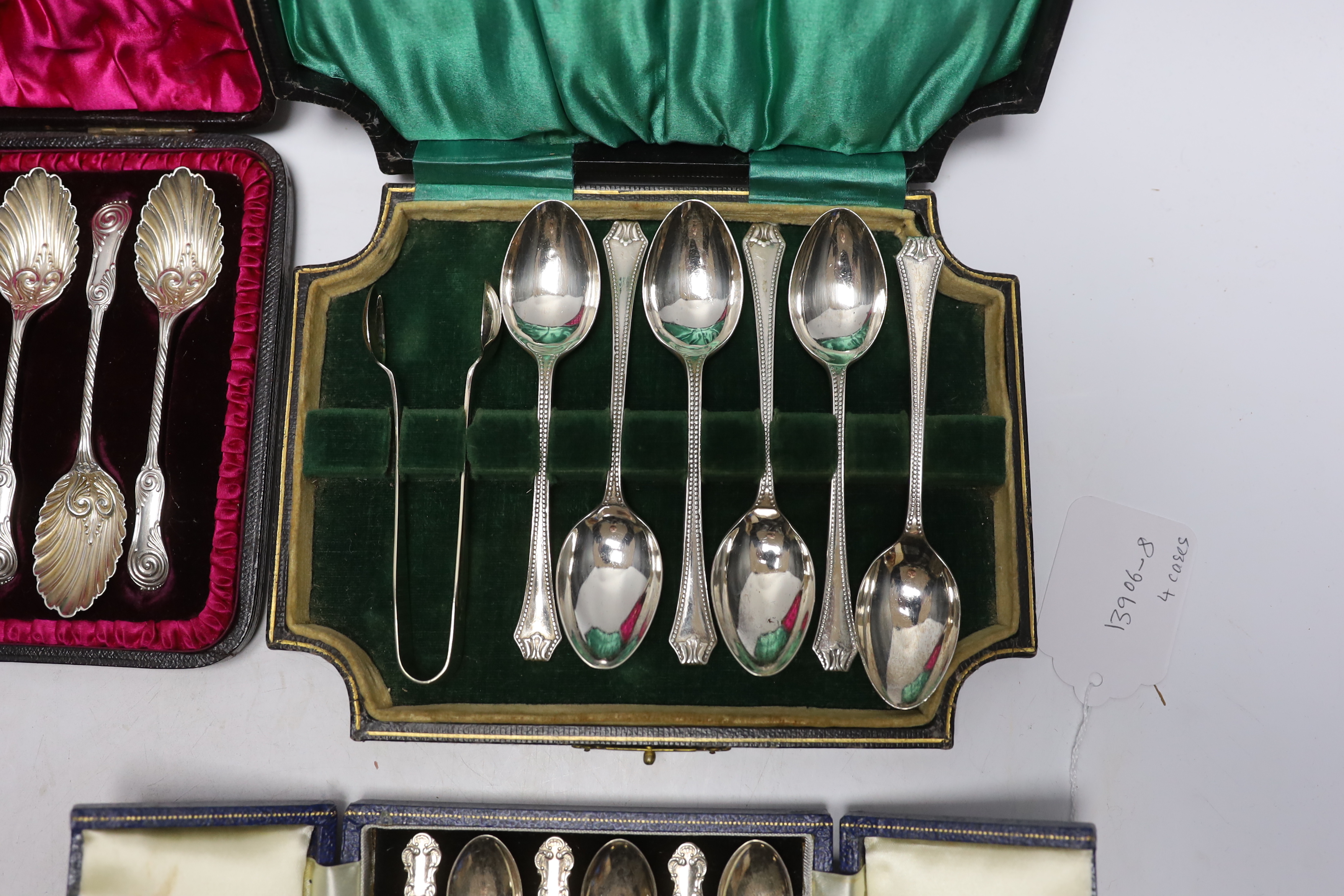 Four assorted sets of six coffee or tea spoons, including two with sugar tongs.